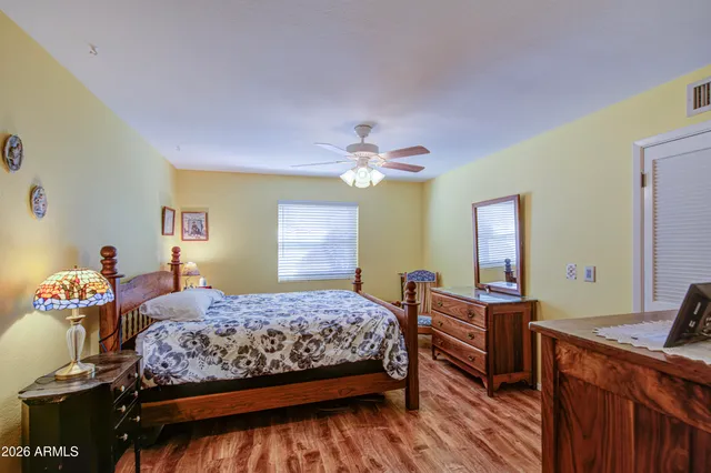 a bedroom with a bed and a chandelier