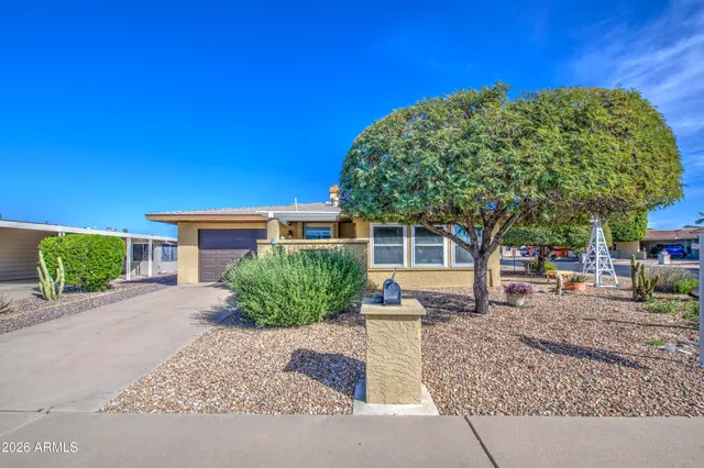 a front view of a house with a garden