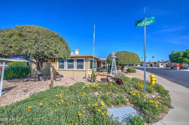 a front view of a house with swimming pool yard and outdoor seating