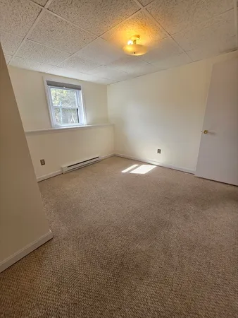 an empty room with windows and painted walls