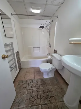 a bathroom with a toilet and a shower