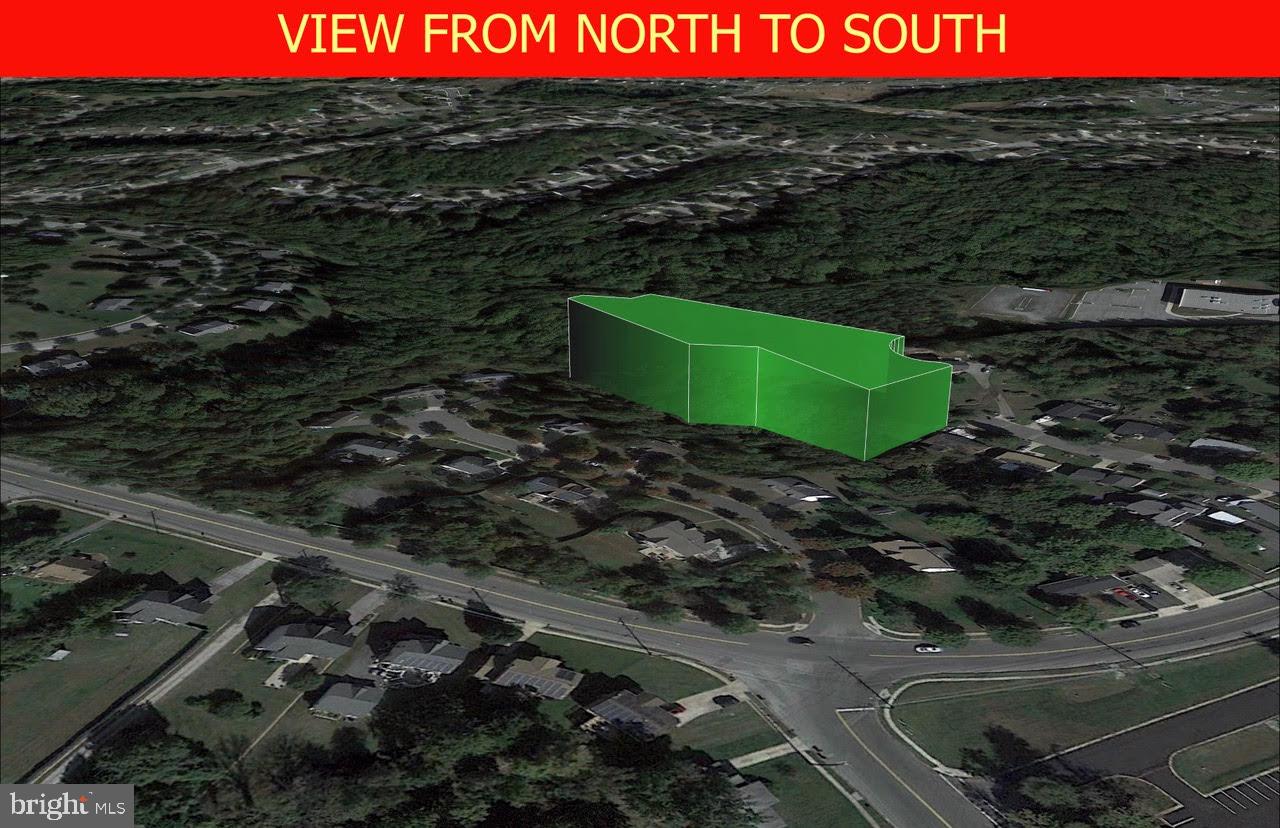 a green field with lots of trees