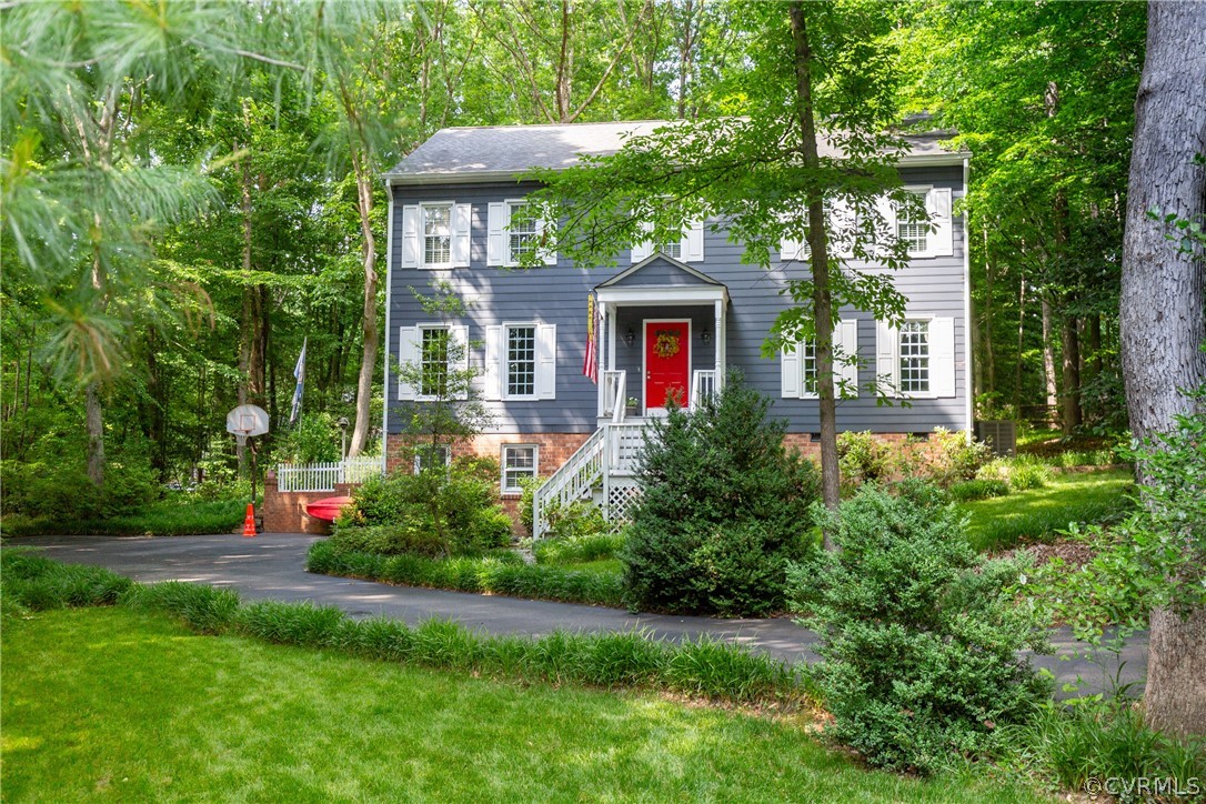 a front view of house with yard and green space
