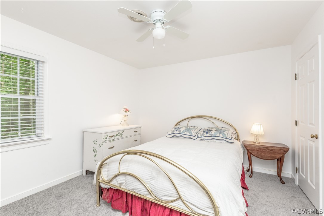 4542 Little Ridge Lane Chesterfield, VA 23832 - Photo 23 of 40 a bed sitting in a bedroom next to a window and a chandelier