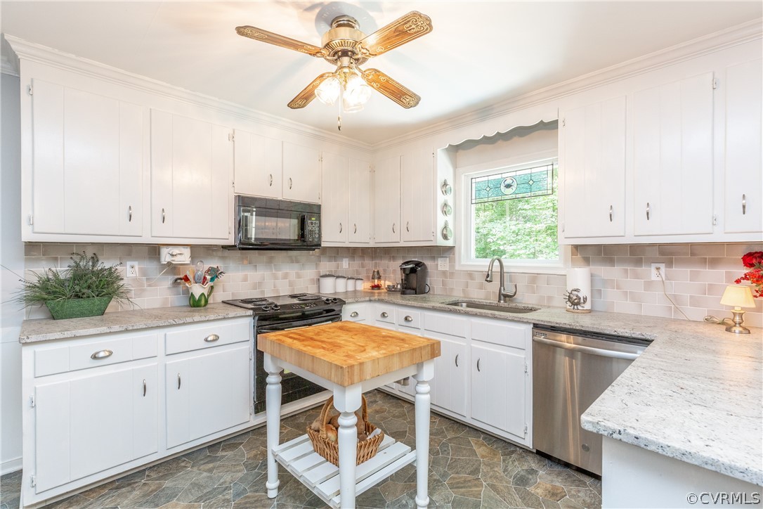 4542 Little Ridge Lane Chesterfield, VA 23832 - Photo 4 of 40 a kitchen with a sink a stove a microwave and cabinets