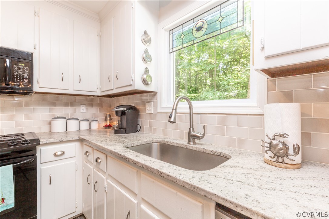 4542 Little Ridge Lane Chesterfield, VA 23832 - Photo 8 of 40 a kitchen with granite countertop a sink stove and cabinets