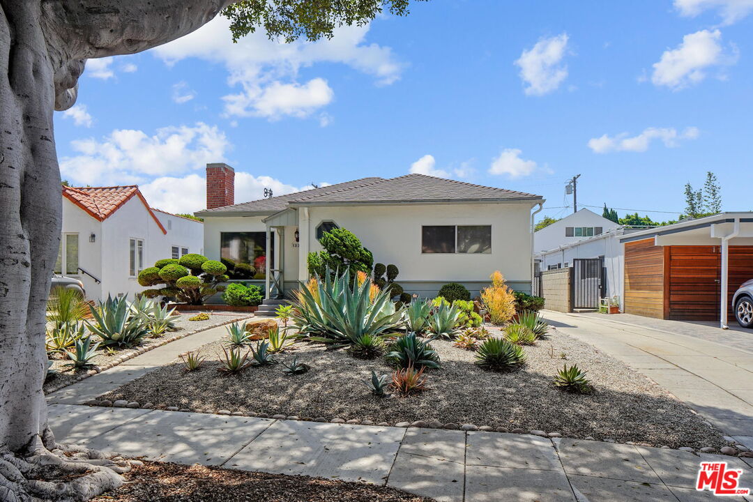 a front view of a house with garden