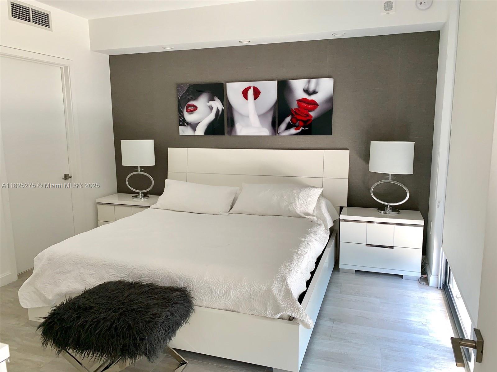 55 Southwest 9th Street, Unit 2706 Miami, FL 33130 - Photo 6 of 8 a bedroom with a bed and wall painting