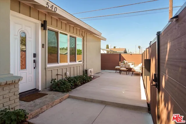 a living room with furniture and kitchen area