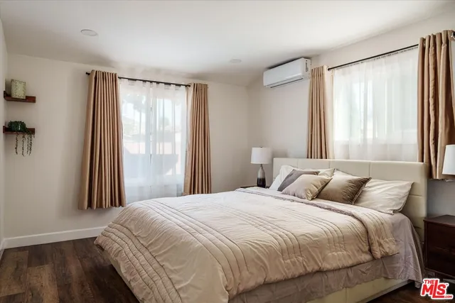 a picture of a room with a white wall and a large window