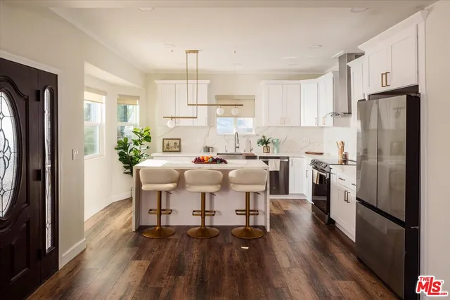 a kitchen with stainless steel appliances granite countertop a stove and a sink