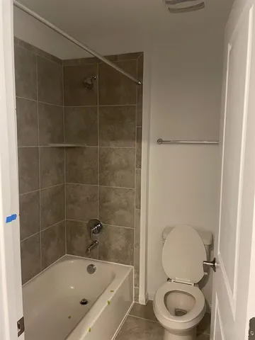 a bathroom with a toilet and a shower