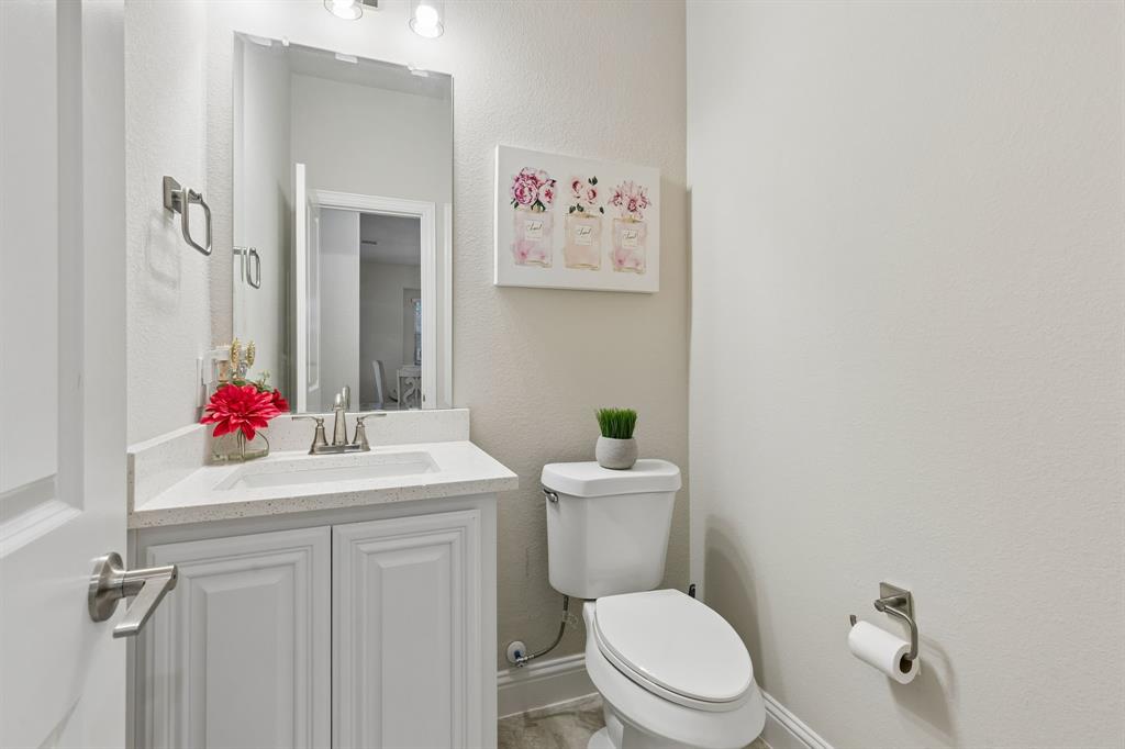 1023 Ridgehurst Road Melissa, TX 75454 - Photo 24 of 39 Bathroom featuring a white vanity with built-in sink, quartz-finish countertop, and brushed nickel faucet