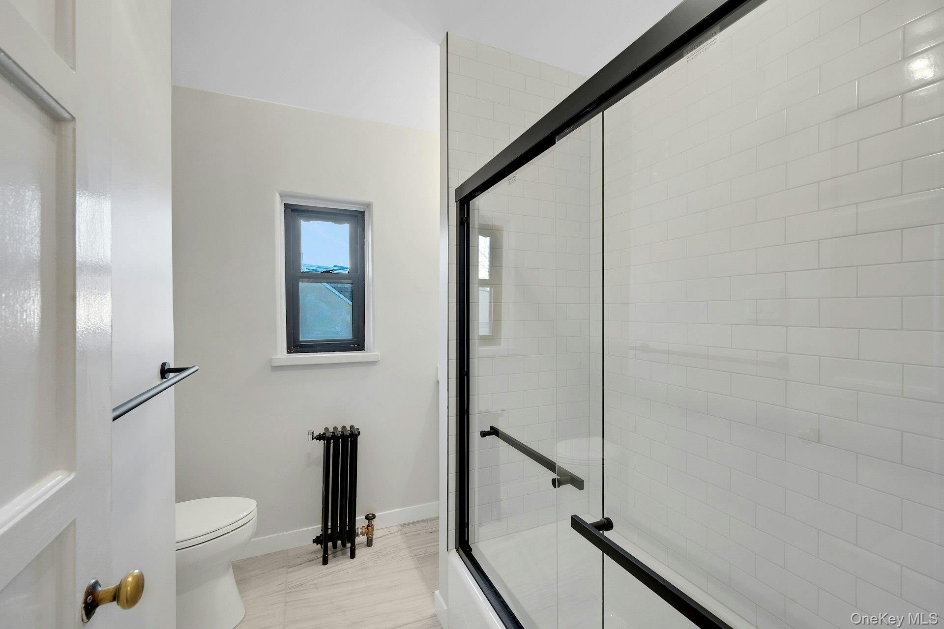 64 Kensington Road, Unit 1B Bronxville, NY 10708 - Photo 14 of 21 Bathroom with Marble Floors, Vanity & Subway Tile
