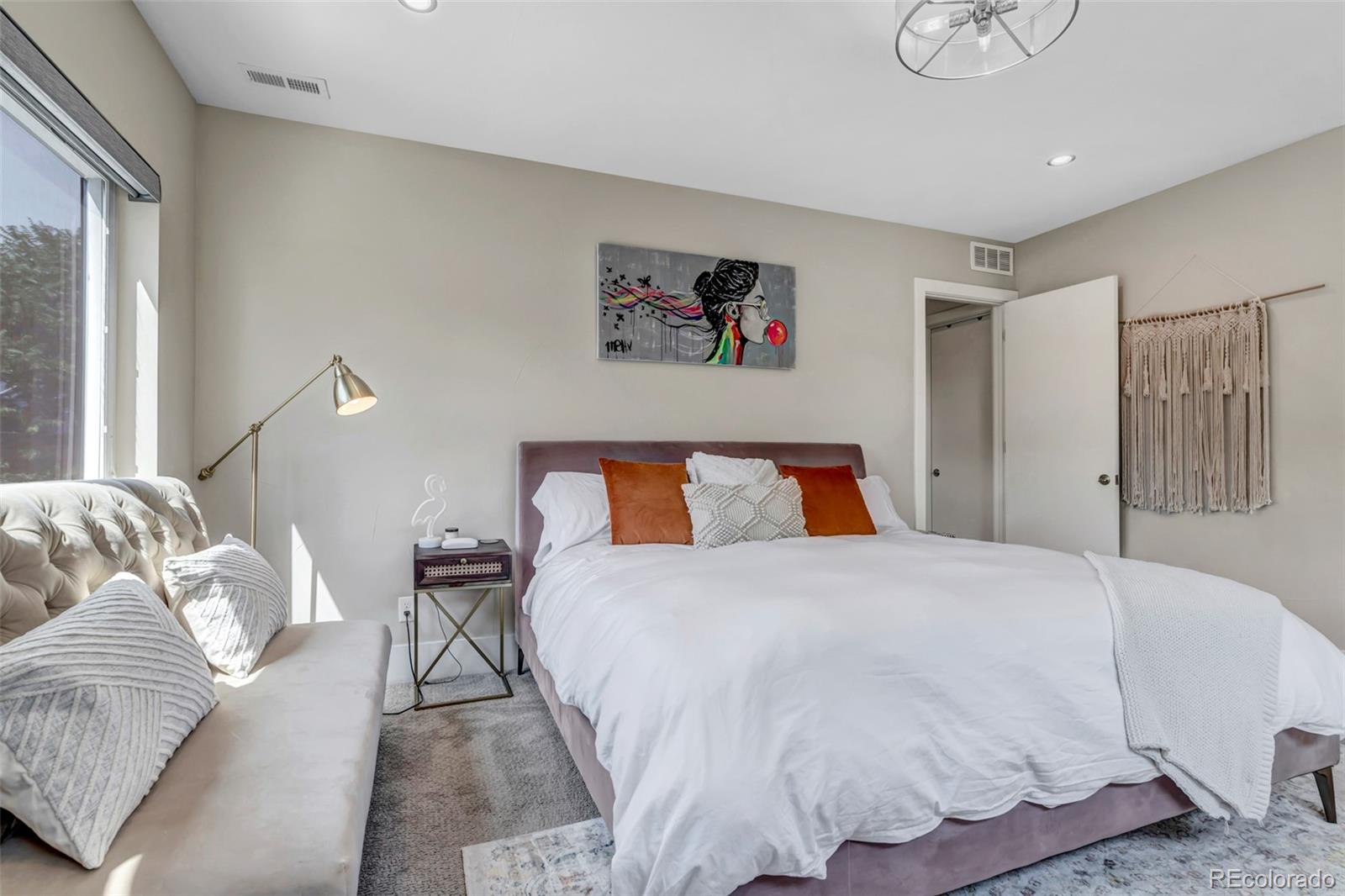 2007 Eliot Street Denver, CO 80211 - Photo 17 of 48 a bedroom with a bed and a couch