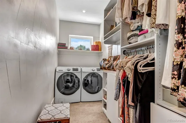 a view of walk in closet with clothes and shoes