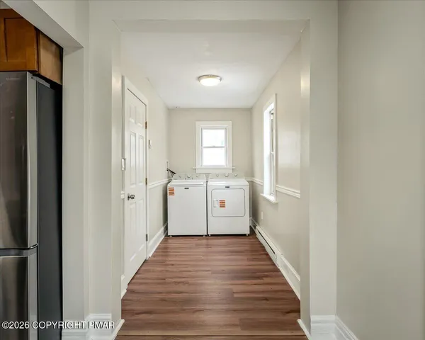 a view of a hallway with a wooden floor