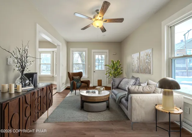 a living room with furniture and a large mirror