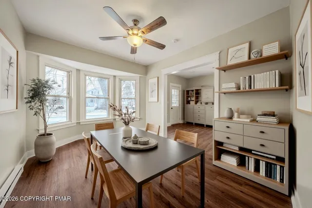 a view of a dining room with furniture window and wooden floor