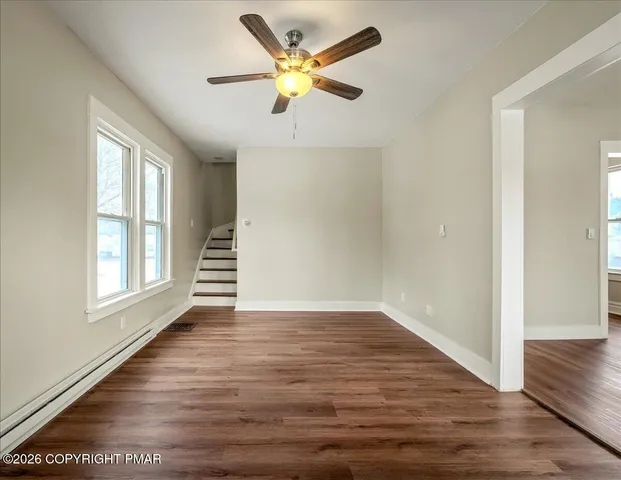 wooden floor in an empty room with a window