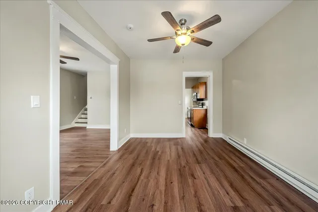 a view of a hallway with wooden floor