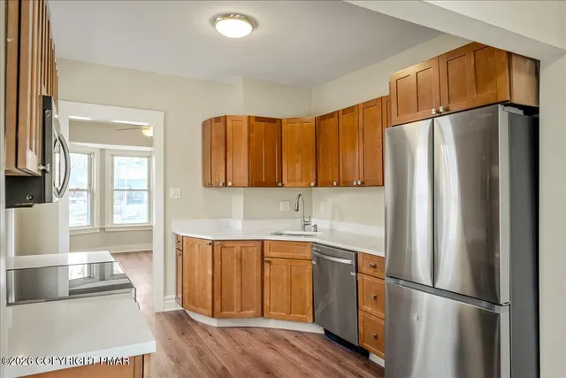 a kitchen with a refrigerator sink and cabinets