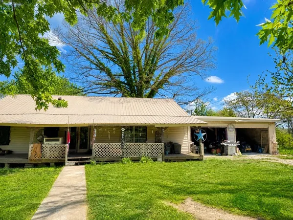 a front view of a house with a garden and porch
