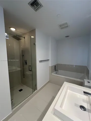 a bathroom with a bathtub and a shower