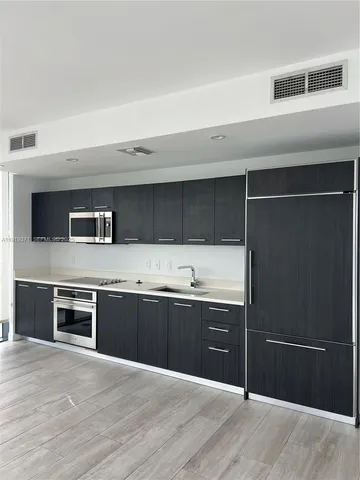 a kitchen with stainless steel appliances granite countertop a stove and a sink