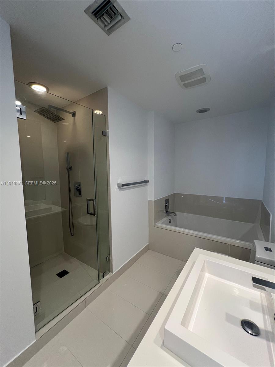 55 Southwest 9th Street, Unit 3406 Miami, FL 33130 - Photo 6 of 6 a bathroom with a bathtub and a shower