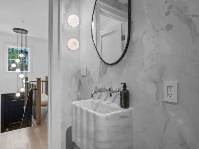 a bathroom with a sink a toilet and a mirror