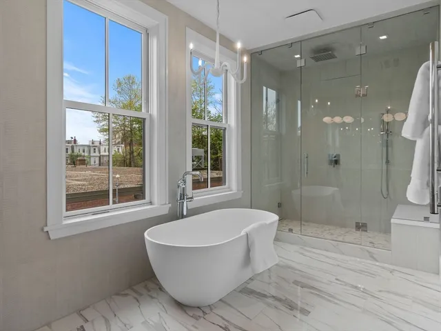 a bathroom with a bathtub and a shower