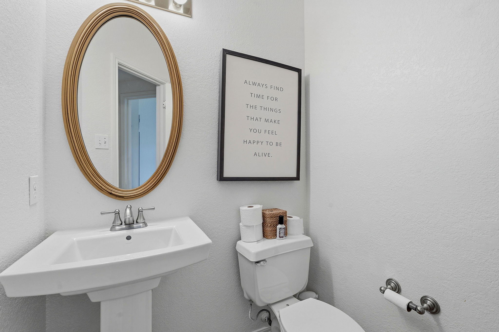 8317 Pommel Drive Austin, TX 78759 - Photo 21 of 26 A well-appointed lavatory boasts a pristine pedestal sink, sleek fixtures, and a stylish oval mirror.