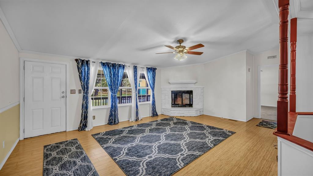 1240 Riverview Road Millsap, TX 76066 - Photo 17 of 36 a bedroom with a bed and a chandelier