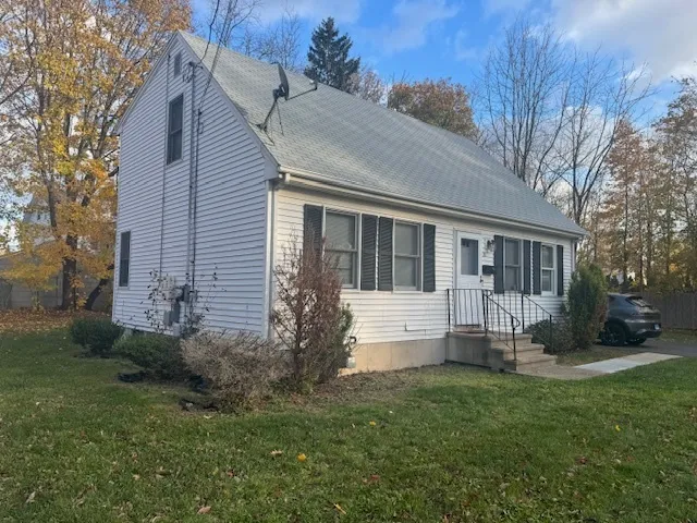a view of a house with a yard and a garden