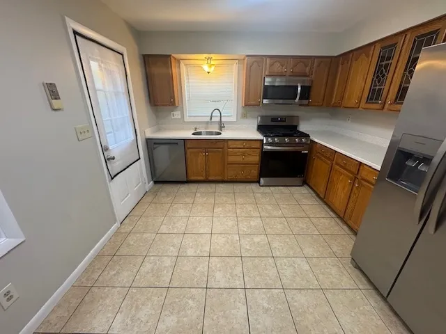 a kitchen with a stove a sink and a microwave