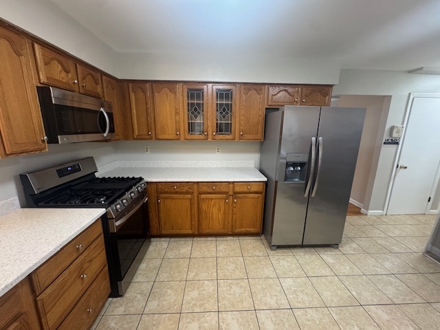 26 Albertson Road Hamden, CT 06514 - Photo 12 of 38 a kitchen with stainless steel appliances granite countertop a refrigerator a stove top oven and sink