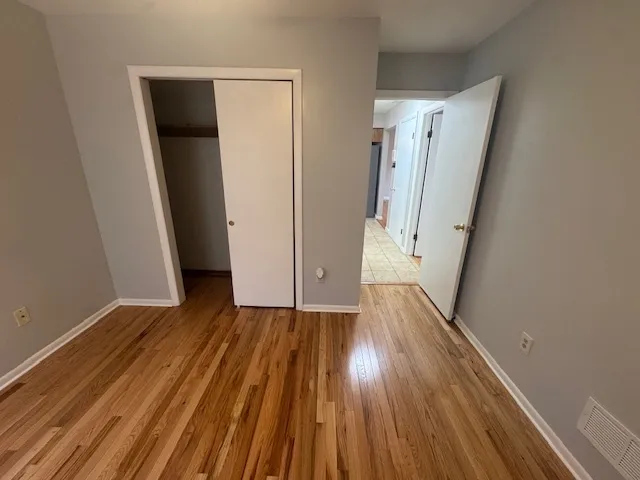 a view of hallway with wooden floor and stairs