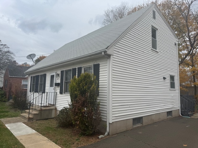 26 Albertson Road Hamden, CT 06514 - Photo 3 of 38 a view of a white house next to a yard