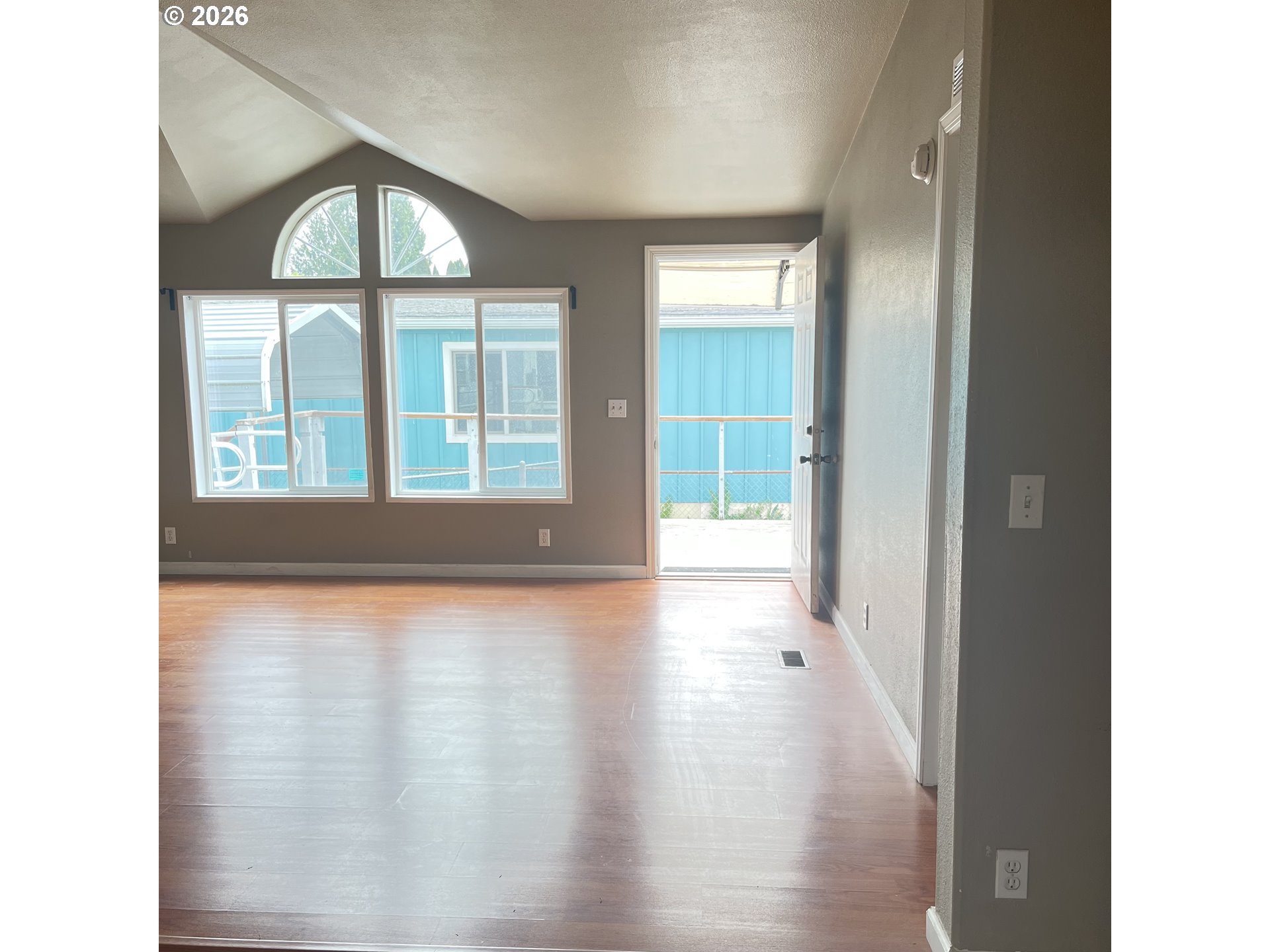 34900 Wendlandt Way, Unit F Scappoose, OR 97056 - Photo 6 of 19 a view of an empty room with wooden floor and a window