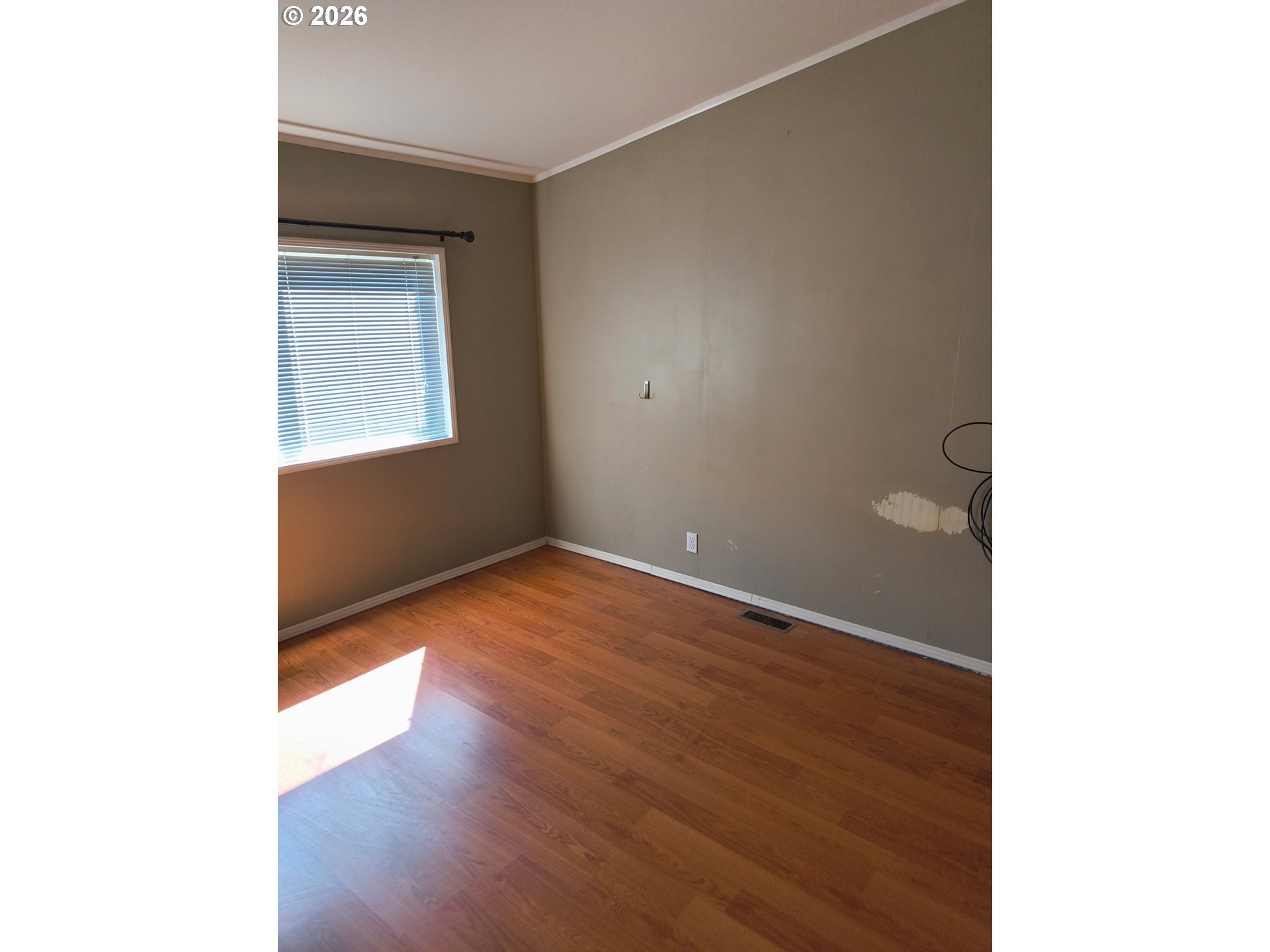 34900 Wendlandt Way, Unit F Scappoose, OR 97056 - Photo 10 of 19 a view of an empty room with wooden floor and a window