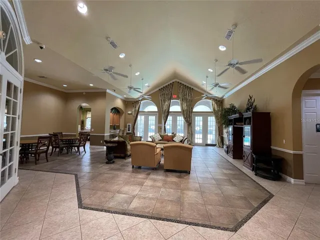a living room with lots of furniture and a large window