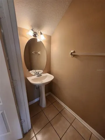 a bathroom with a sink toilet and a mirror