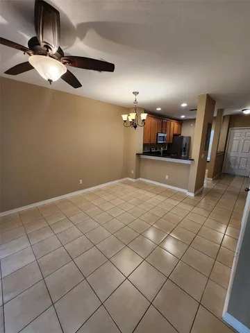 a view of a kitchen with a sink and chandelier fan