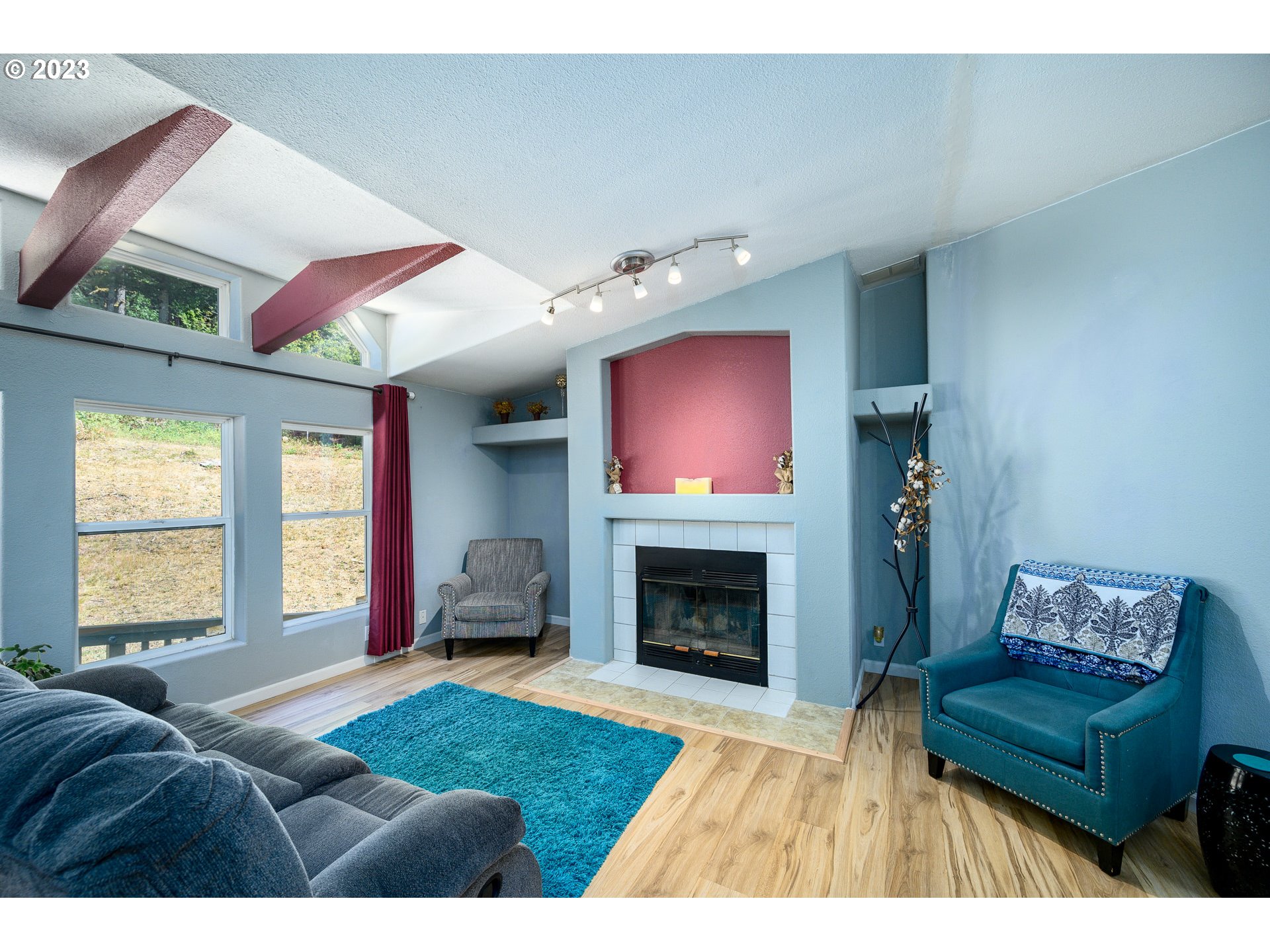 22575 Southwest Grand Ronde Road Grand Ronde, OR 97347 - Photo 13 of 46 a living room with furniture window and a fireplace