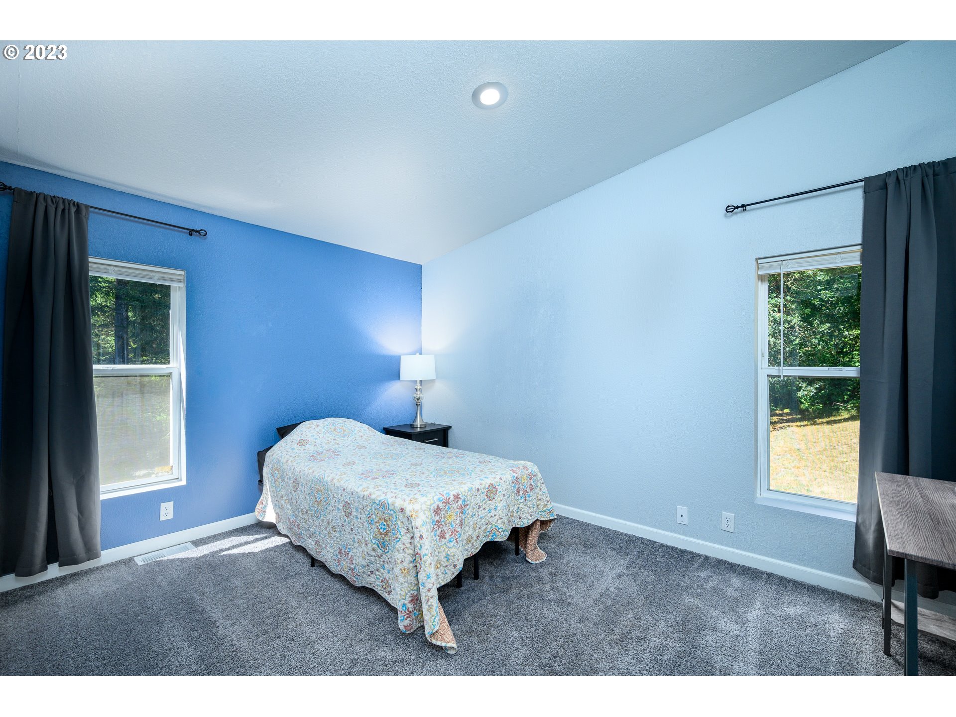 22575 Southwest Grand Ronde Road Grand Ronde, OR 97347 - Photo 31 of 46 a bedroom with a bed lamps and a window