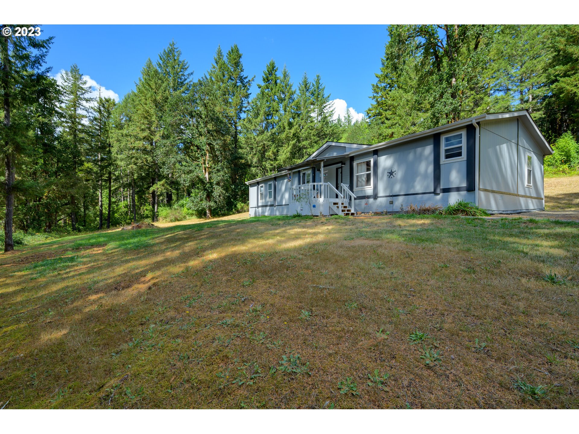 22575 Southwest Grand Ronde Road Grand Ronde, OR 97347 - Photo 8 of 46 a backyard of a house with lots of green space