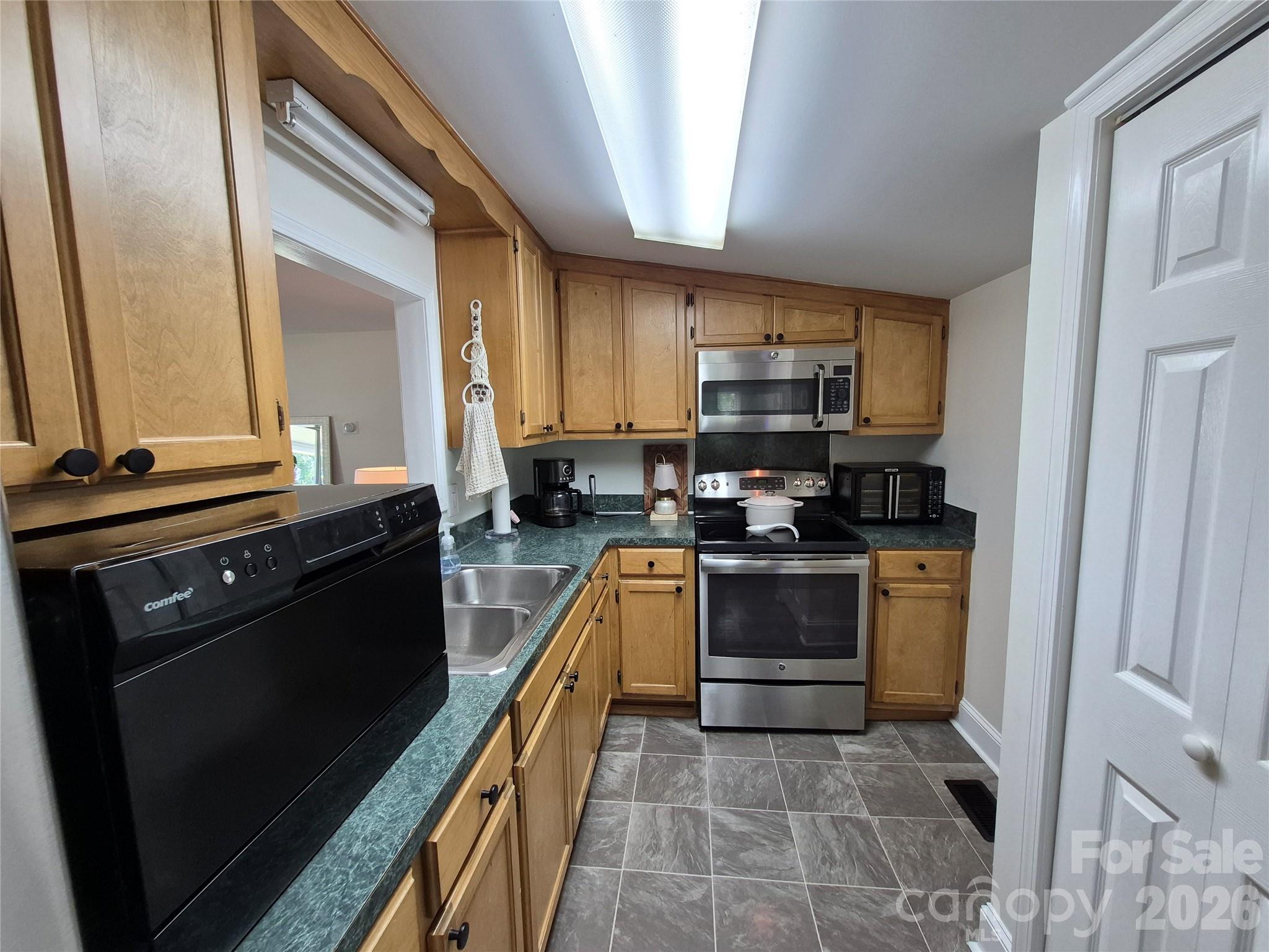 4438 Reepsville Road Vale, NC 28168 - Photo 17 of 32 a kitchen with a sink stove and cabinets