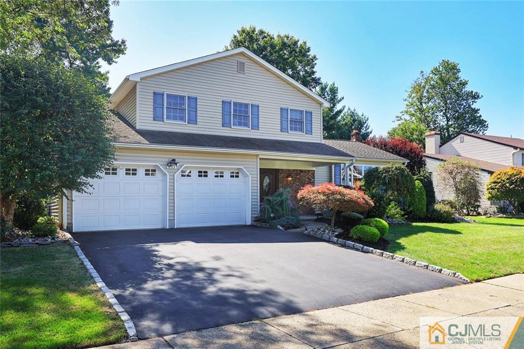 203 Normandy Road Edison, NJ 08820 - Photo 1 of 32 a front view of a house with a yard and garage