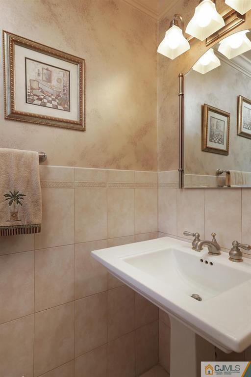 203 Normandy Road Edison, NJ 08820 - Photo 13 of 32 a bathroom with a sink and a mirror
